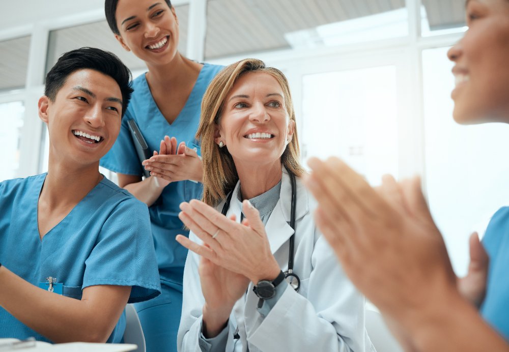 Care team applauding during a huddle